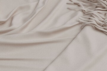 Soft, light beige draped fabric with fringe details