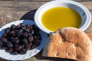 Africa, Tunisia, Zaghouan. Freshly harvested olives paired with olive oil and handmade bread.