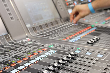 Sound engineer hands adjusting control sound mixer in recording, broadcasting studio