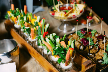 Healthy vegetable crudités in glasses with dip.