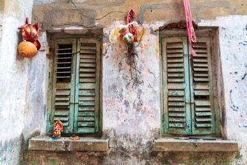 India, West Bengal, Kolkata, College Square. Weathered wall and window shutters.