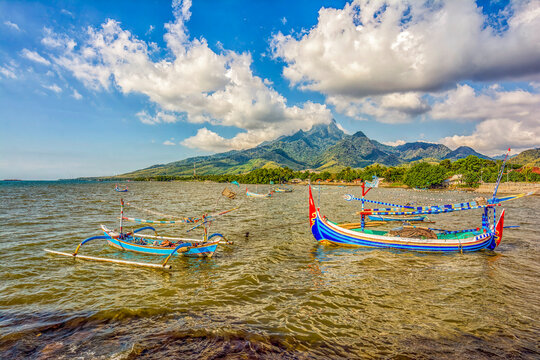 Java, Indonesia. Wide angle landscape view of outriggers lining the coastline and beaches.