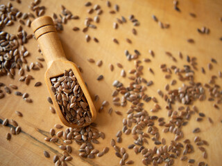 flax seeds in a rustic wooden bowl on a wooden table with copy space