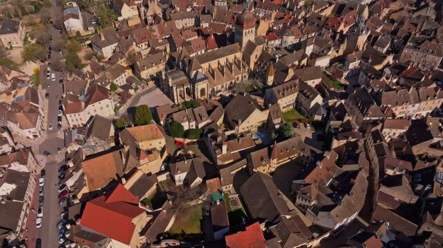 Drone view of blooming trees and rooftops in Beaune. Aerial drone video