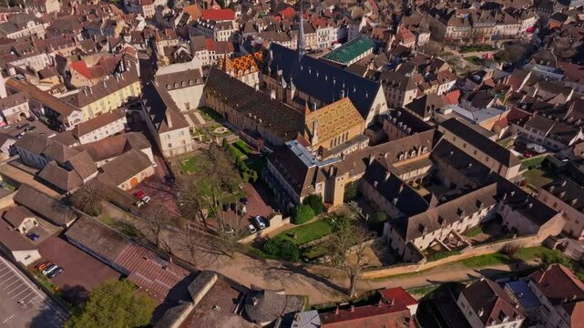 Heritage building with vivid glazed tiles in Beaune. Aerial drone video