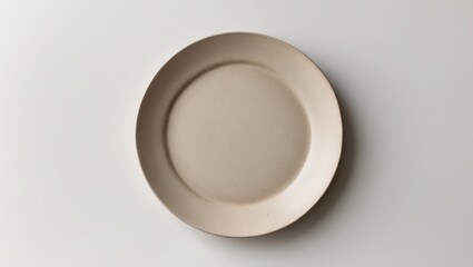 Handmade Ceramic Dish Plate with Trendy Circle Beige Sand Grain Texture, Top View on White Background