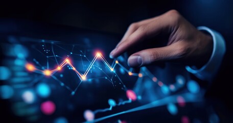 Hand interacts with digital display showing a line graph with glowing points.