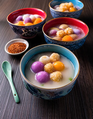 Colorful bowls of Taiwanese Taro Balls with sweet potato balls and various toppings in a sweet soup represent a popular chewy dessert.