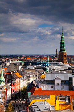 Christiansborg Palace tower and NASDAQ Copenhagen. Oresund Bridge in distance, Copenhagen, Denmark.