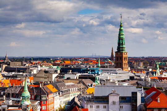 Christiansborg Palace tower and NASDAQ Copenhagen. Oresund Bridge in distance, Copenhagen, Denmark.