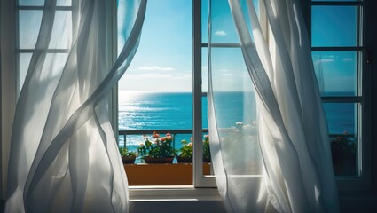 Obraz premium Daytime scene of a room with a window and white curtains overlooking the sea