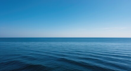Obraz premium Seaside landscape showcasing a sea horizon and mostly clear deep blue sky - Background