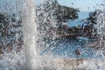 Abstract close-up of water splashing from a fountain with dynamic texture and motion