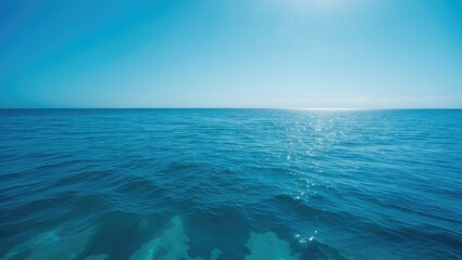 Fototapeta premium Vertical front view of a landscape with a calm blue sea and sky in the morning during summer