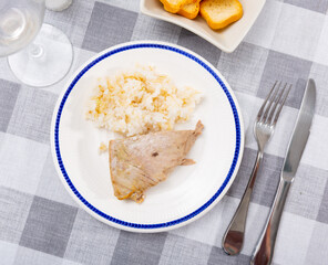 Just prepared fresh tuna fillet served with boiled rice on plate.