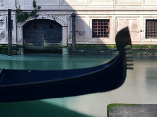 Long exposure photo of Gondola moored in canal. Detail. Venice, Italy.