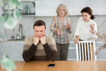 Family quarrel, two women of differen age blaming man