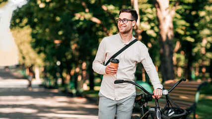 Healthy and active lifestyle, going to work on eco transport. Smiling attractive millennial man...