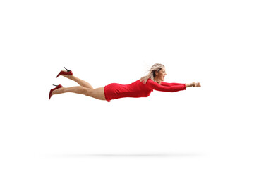 Attractive woman in a red dress flying