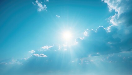 Bright day scenery with a blue sky filled with cumulus clouds and sunlight as a natural backdrop.