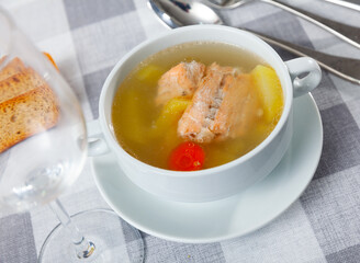Portion of soup made of salmon offal served on table.