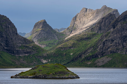 Norway, Lofoten. Island in fjord and mountain landscape.