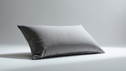 Cushion in gray on the backdrop. Pillow featuring a canvas cover set against the background.