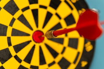 Dart hitting the bullseye on a colorful dartboard in a casual game environment