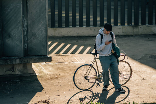 top view of a young man with bicycle and mobile phone