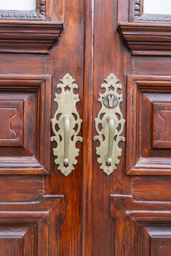 Angra do Heroismo, Terceira Island, Azores, Portugal. Brass handles on old wooden doors.
