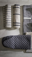 Collection of kitchen linens and textiles arranged on a neutral surface for decorative display and styling inspiration.