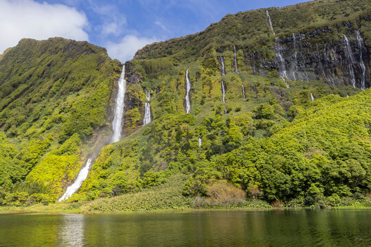 Azores, Portugal. Waterfall dropping into Lagoa dos Patos on Flores Island.
