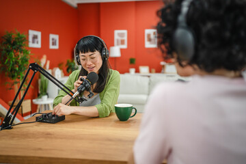 women in the podcast, focus on a japanese woman talk into a mic