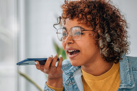 girl with mobile phone sending or recording voice message