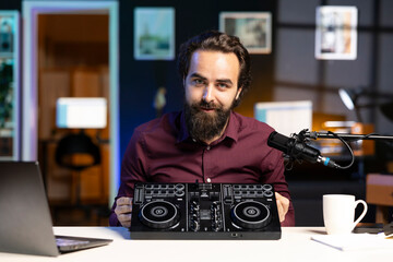 Content creator filming technology review of newly released DJ controller, unboxing it, excited to...