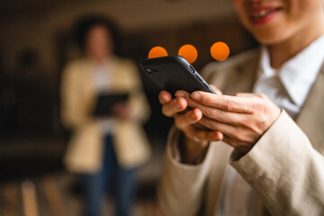 close up on businesswoman use mobile phone for research or fun on work