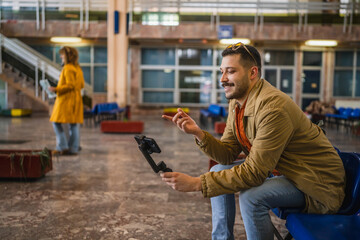 welcoming man travel blog tourist record a video blog on train station