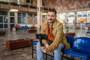 welcoming man travel blog tourist record a video blog on train station
