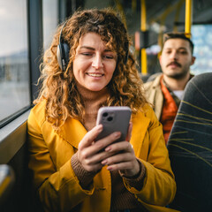 young adult woman use public transport, sit with phone and headphones