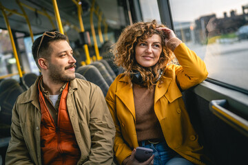 adult couple or friends smile and enjoy on a bus ride