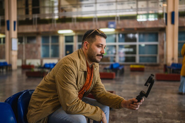 welcoming man travel blog tourist record a video blog on train station