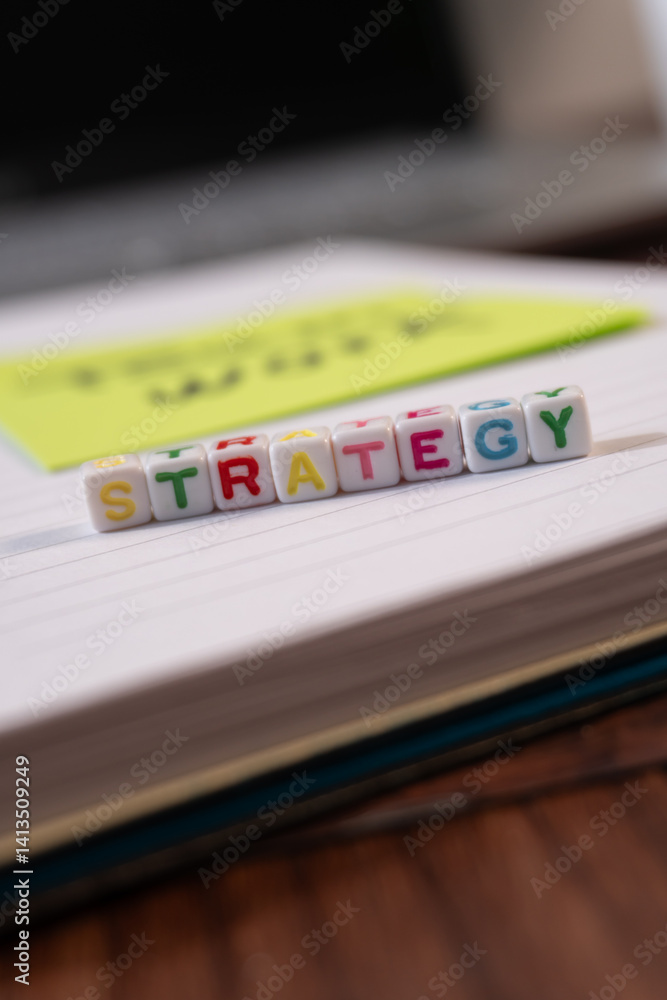 Poster a stack of colorful cubes with the word strategy written on them. the cubes are arranged in a way th