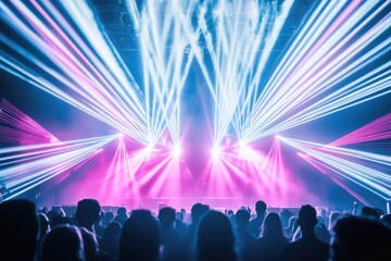 Vibrant laser lights illuminate a crowded concert venue, creating an electrifying atmosphere.