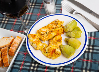 Homemade spicy grilled chicken with artichokes, healthy dinner