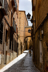 Picturesque cityscape of historic area of Toledo overlooking typical narrow cobblestone streets on sunny spring day, Spain..