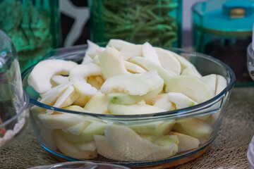 A fresh cut guava fruit , placed on a wooden surface, highlighting its tropical appeal and juicy texture.