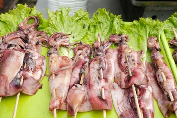 Raw squids satay, ready to grill. One of the street food in Asia. Cumi-cumi