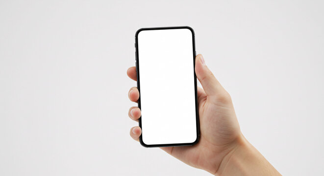Smartphone in hand: A close-up shot shows a hand gracefully holding a modern smartphone, its blank screen offering endless possibilities. Explore the connection between technology and the user.