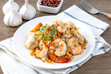 Fried shrimp with garlic and pepper on white plate - seafood style