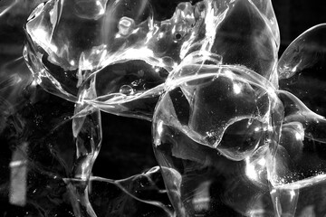 abstract image of large white blown bubbles against black 